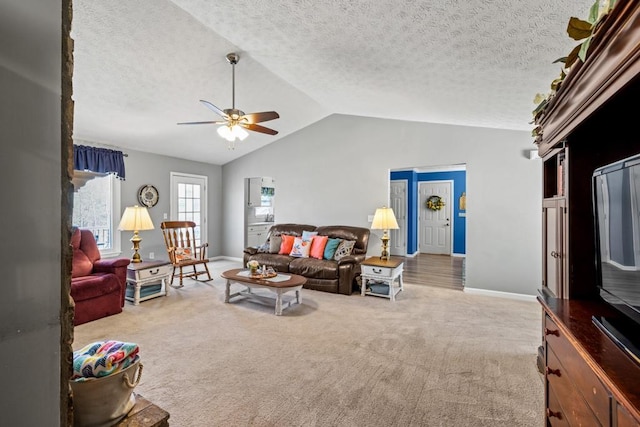 carpeted living room with ceiling fan, a textured ceiling, and vaulted ceiling