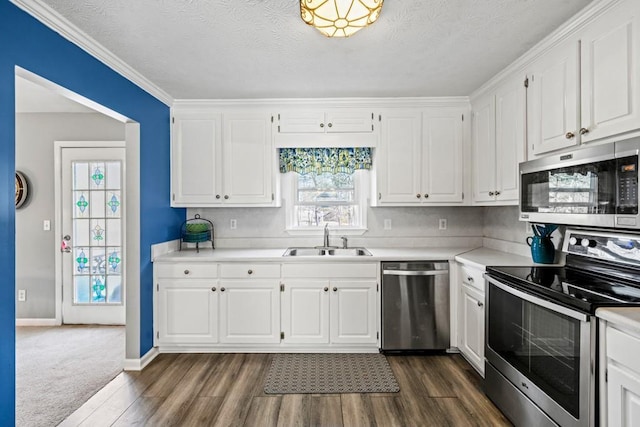 kitchen with white cabinets, sink, appliances with stainless steel finishes, and a textured ceiling