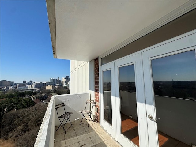 balcony featuring a city view and french doors