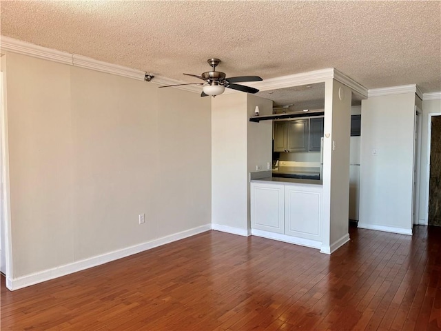 unfurnished living room featuring ornamental molding, a ceiling fan, a textured ceiling, dark wood-style floors, and baseboards