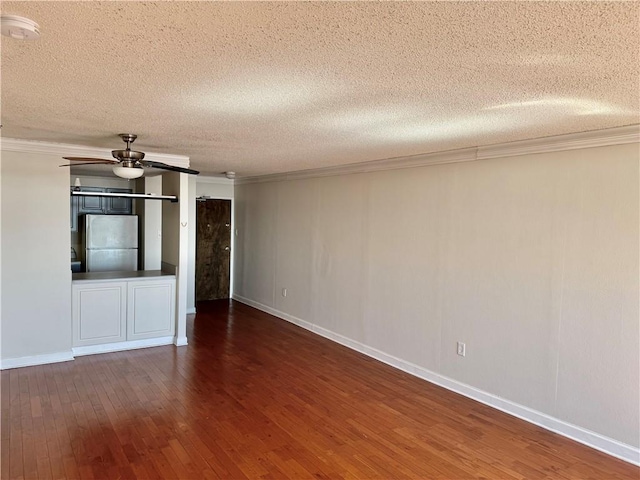 unfurnished room with a textured ceiling, crown molding, wood-type flooring, and ceiling fan