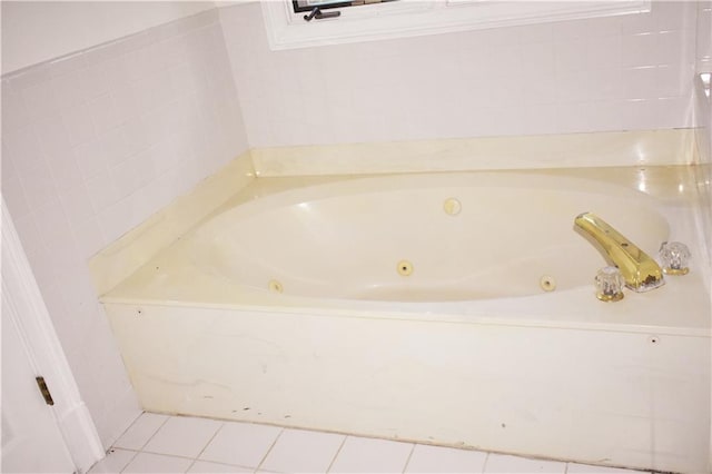 full bathroom featuring tile patterned floors and a jetted tub