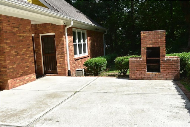 view of patio featuring a fireplace