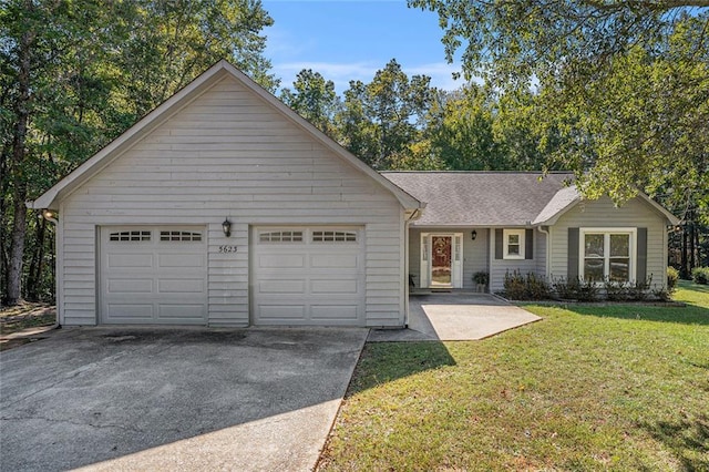 ranch-style house featuring a front lawn and a garage