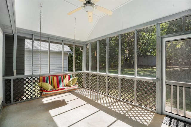 unfurnished sunroom featuring ceiling fan and a healthy amount of sunlight