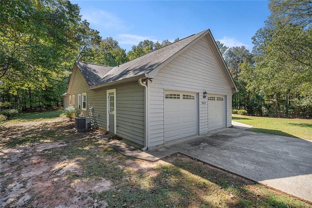 garage featuring a yard and cooling unit