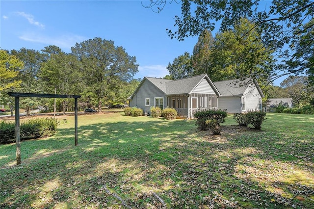 exterior space featuring a front yard and a sunroom