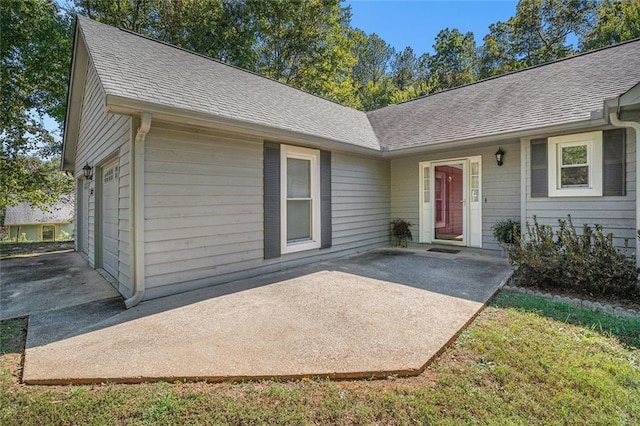 view of exterior entry with a garage