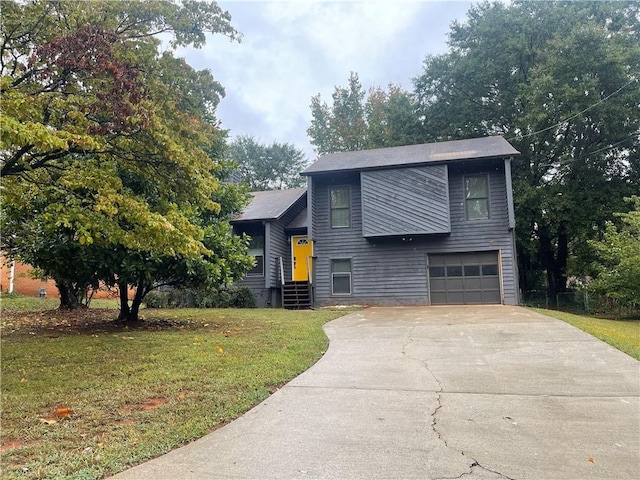 view of front of home with a front lawn and a garage