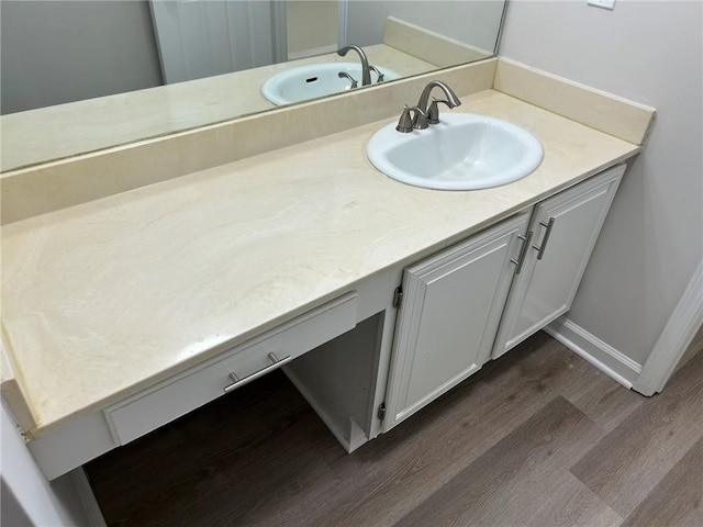 bathroom with vanity and wood-type flooring