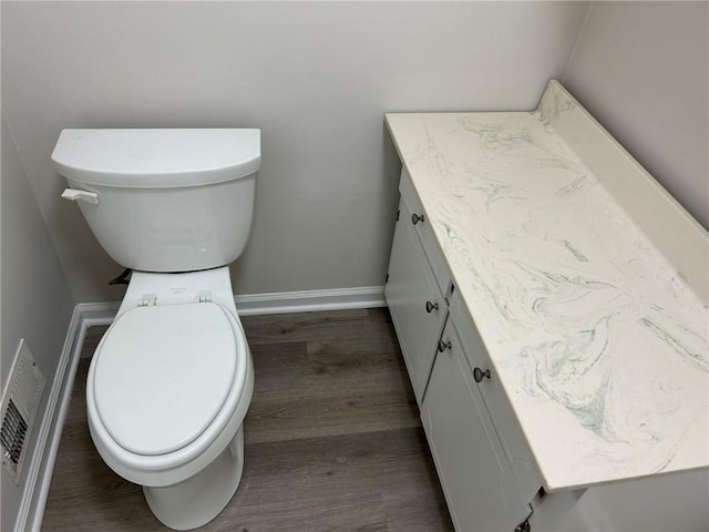 bathroom featuring hardwood / wood-style flooring, vanity, and toilet