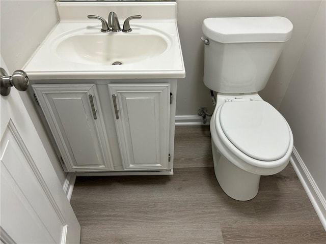 bathroom with vanity, hardwood / wood-style floors, and toilet