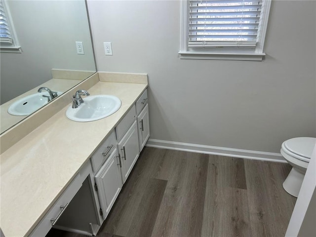 bathroom featuring hardwood / wood-style flooring, vanity, and toilet