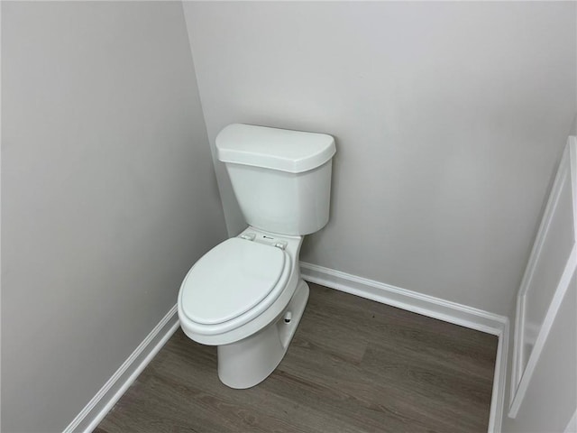 bathroom featuring wood-type flooring and toilet