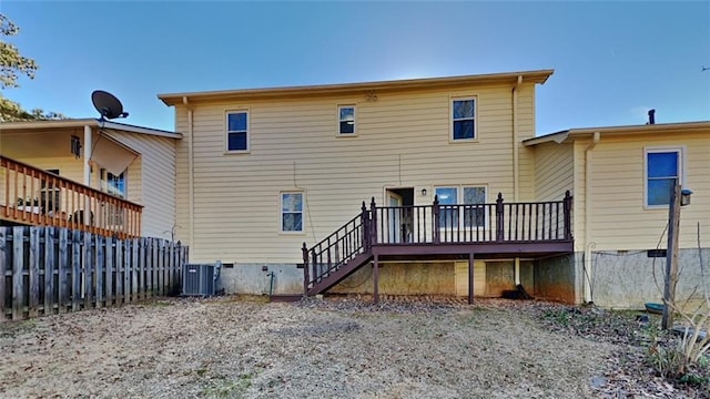 back of house featuring central AC and a deck