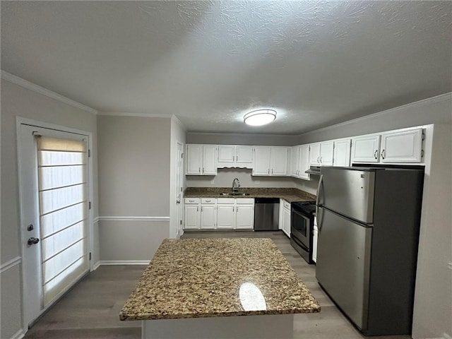 kitchen featuring white cabinetry, light stone countertops, appliances with stainless steel finishes, and sink