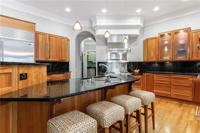 1255 Beech Haven Rd NE, Atlanta, GA 30324 - kitchen featuring a sink, tasteful backsplash, ornamental molding, built in fridge, and brown cabinets
