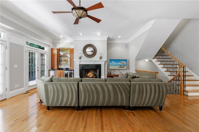 1255 Beech Haven Rd NE, Atlanta, GA 30324 - living room with light wood-type flooring, ornamental molding, ceiling fan, recessed lighting, and stairway