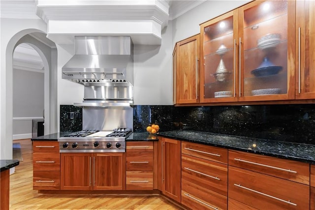 1255 Beech Haven Rd NE, Atlanta, GA 30324 - kitchen featuring light wood-type flooring, brown cabinetry, dark stone countertops, and crown molding
