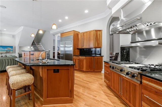 1255 Beech Haven Rd NE, Atlanta, GA 30324 - kitchen featuring appliances with stainless steel finishes, wall chimney exhaust hood, a sink, tasteful backsplash, and ornamental molding