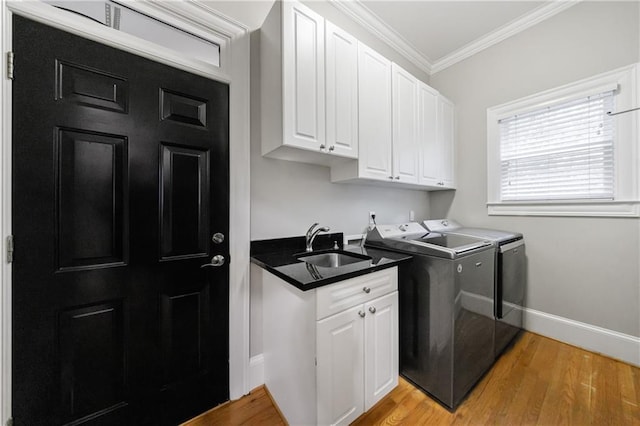 1255 Beech Haven Rd NE, Atlanta, GA 30324 - washroom featuring washing machine and clothes dryer, crown molding, cabinet space, light wood-type flooring, and baseboards
