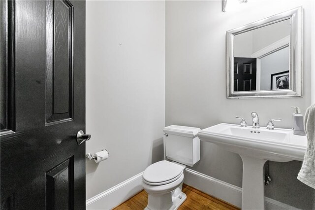 1255 Beech Haven Rd NE, Atlanta, GA 30324 - half bathroom with wood finished floors, toilet, and baseboards
