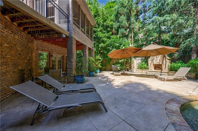 1255 Beech Haven Rd NE, Atlanta, GA 30324 - view of patio featuring an outdoor stone fireplace and french doors