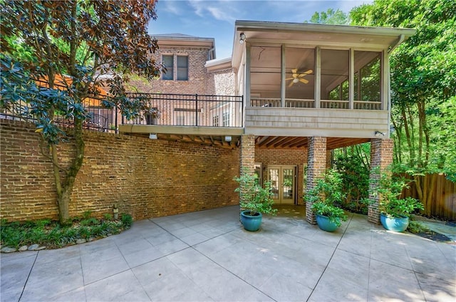 1255 Beech Haven Rd NE, Atlanta, GA 30324 - rear view of property featuring a patio, brick siding, a sunroom, and french doors
