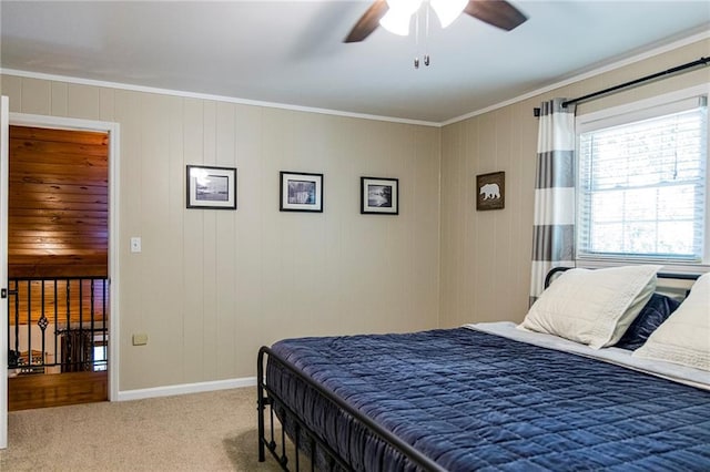 carpeted bedroom with crown molding and ceiling fan