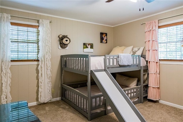 carpeted bedroom featuring ornamental molding and ceiling fan