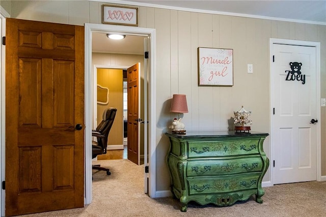 interior space featuring crown molding and light carpet