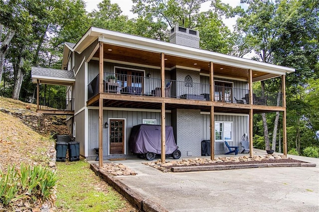 back of property featuring a balcony