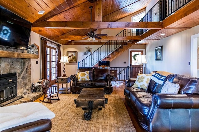 living room featuring a fireplace, vaulted ceiling with beams, hardwood / wood-style flooring, wooden ceiling, and french doors