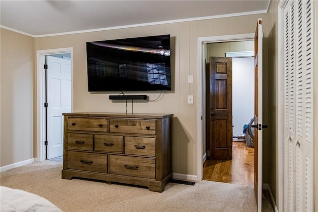 bedroom featuring light carpet and ornamental molding