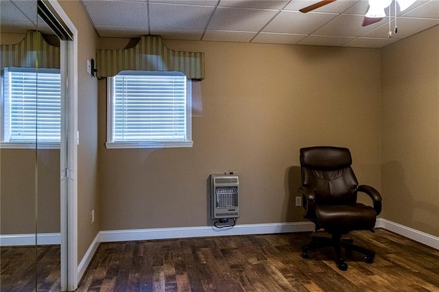 unfurnished room featuring heating unit, hardwood / wood-style floors, a paneled ceiling, and ceiling fan