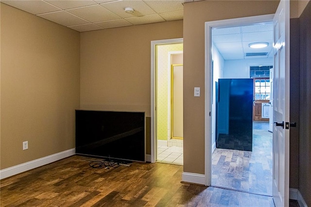 interior space with dark hardwood / wood-style flooring and a paneled ceiling