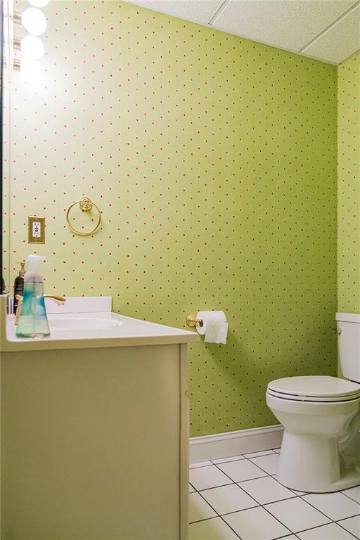 bathroom featuring tile patterned floors, toilet, and vanity