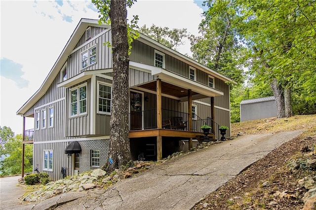 back of house featuring covered porch