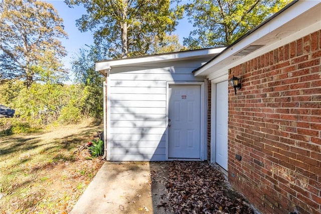 doorway to property with brick siding