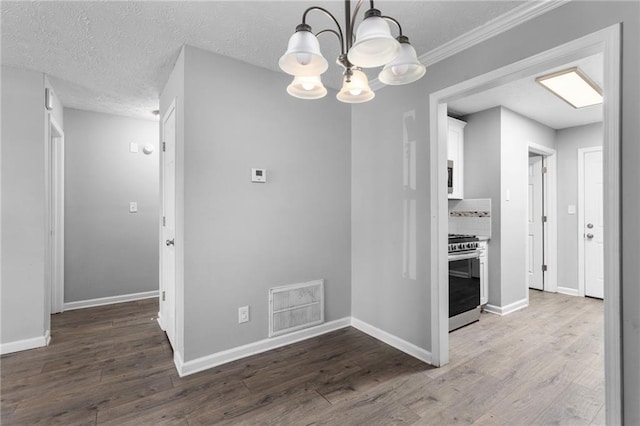 interior space featuring visible vents, baseboards, and wood finished floors