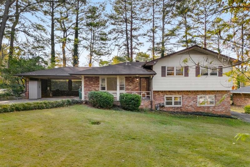 split level home with a front yard and a carport