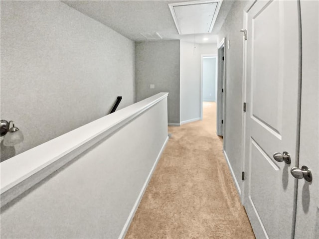 corridor featuring light colored carpet