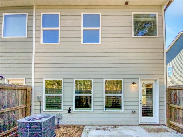 rear view of house with central AC unit