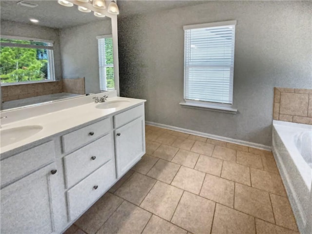 bathroom with a bath, tile patterned floors, and vanity