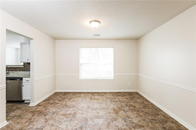 empty room featuring a textured ceiling