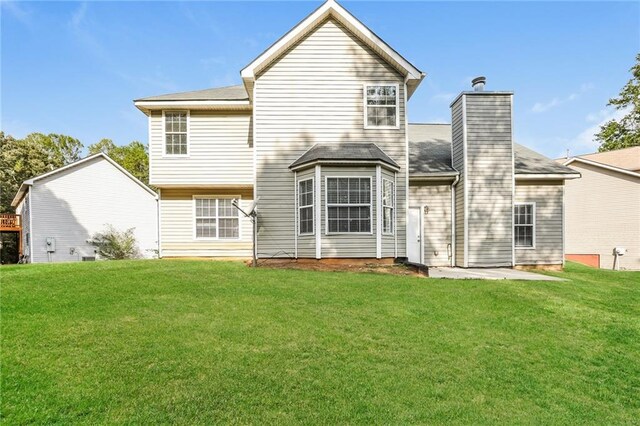 back of house featuring a yard and a patio