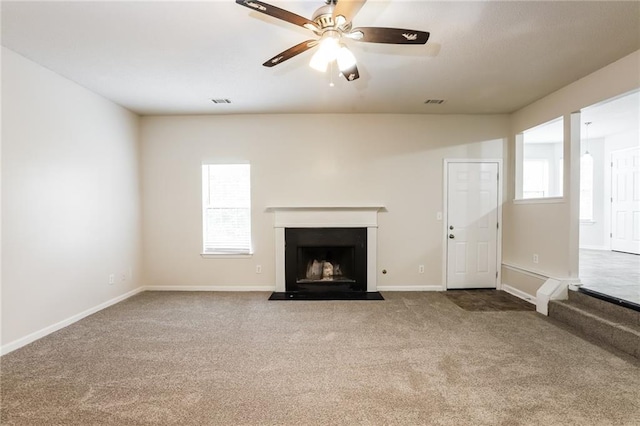 unfurnished living room with carpet floors and ceiling fan