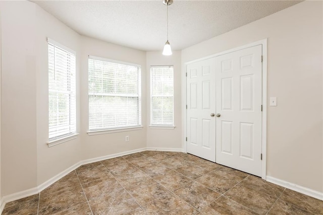 spare room with a healthy amount of sunlight and a textured ceiling