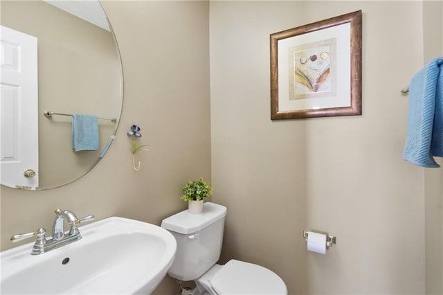 bathroom with toilet and a sink