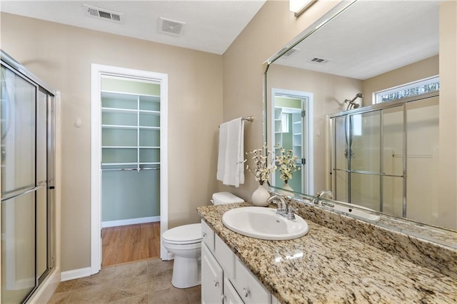 bathroom with visible vents and a shower stall